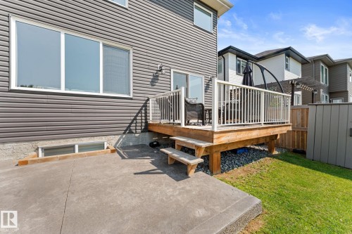 Elevated wood deck with white railing, accessed via sliding glass doors - 12383 176 Avenue Nw, Edmonton, AB - Outdoor With Deck Patio Veranda With Exterior