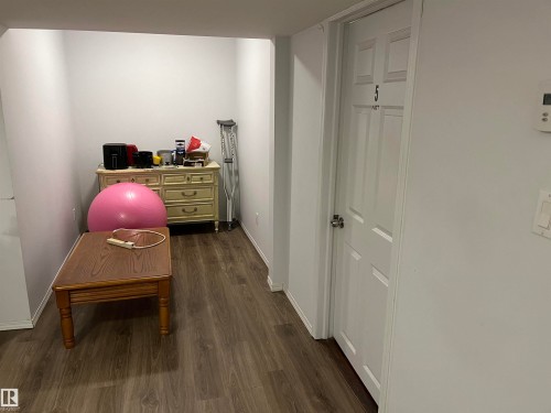 Versatile bonus room or home office featuring wood-finish flooring, generous linear dimensions, and ample natural light - 12011 87 Avenue Nw, Edmonton, AB - Indoor