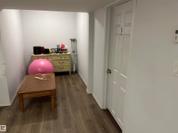 Versatile bonus room or home office featuring wood-finish flooring, generous linear dimensions, and ample natural light - 