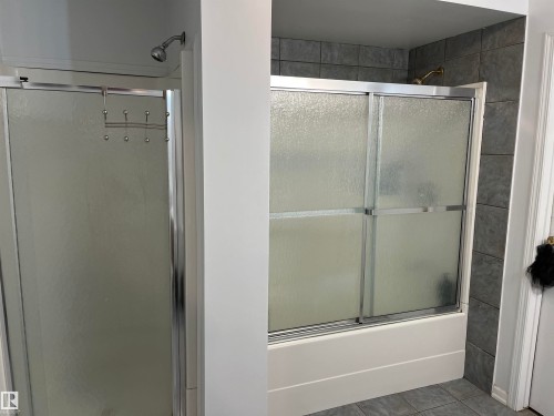 Primary Bathroom Suite Featuring Dual Shower Enclosures with Frameless Glass Doors and Chrome Hardware, Complemented by Subway Tile Accent Wall and Contemporary Fixtures Throughout - 12011 87 Avenue Nw, Edmonton, AB - Indoor Photo Showing Bathroom