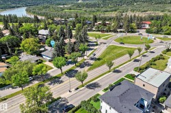Aerial view showcasing a residential area with varied rooflines and extensive tree coverage - 