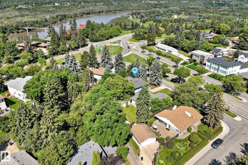 Aerial perspective showcasing a residential area with mature trees and a nearby body of water - 12011 87 Avenue Nw, Edmonton, AB - Outdoor With View