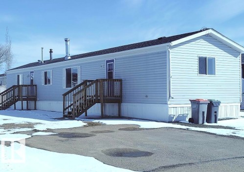 Single-story residence featuring light blue siding and a dark shingle roof - 42 Midland Road, Millet, AB - Outdoor With Exterior