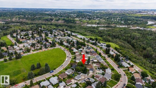 Aerial view showcasing this established residential community featuring tree-lined streets, curved cul-de-sacs, and single-family homes on generous lots - 10513 42 Street Nw, Edmonton, AB 