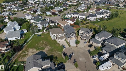 Residential cul-de-sac with multiple detached properties, surrounded by green spaces and paved streets - 34 Mckenzie Close Close, Leduc, AB - Outdoor With View