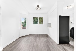 Spacious room featuring light wood-finish flooring and multiple windows providing natural illumination - 