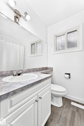 Bathroom featuring a vanity with an integrated sink and a marbled countertop - 5519 142 Avenue Nw, Edmonton, AB - Indoor Photo Showing Bathroom