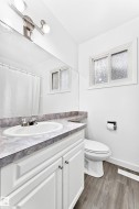 Bathroom featuring a vanity with an integrated sink and a marbled countertop - 