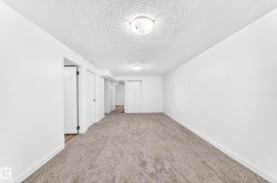 Neutral-toned wall-to-wall carpeting complements the white walls and trim - 