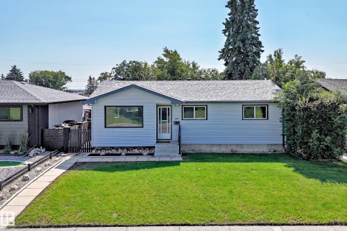 Light blue siding exterior with dark-trimmed windows and a gray shingle roof - 5519 142 Avenue Nw, Edmonton, AB - Outdoor
