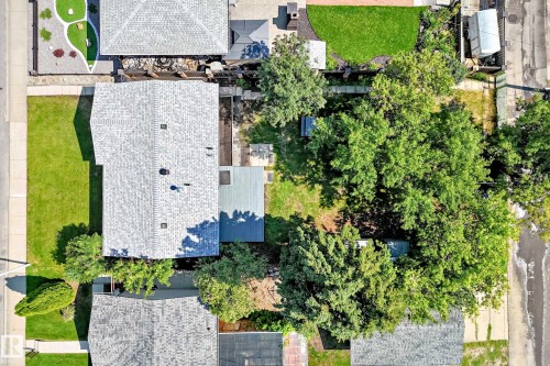 Expansive property with a gabled roofline and a large, tree-filled backyard - 5519 142 Avenue Nw, Edmonton, AB - Outdoor