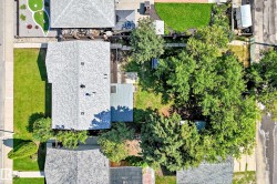 Expansive property with a gabled roofline and a large, tree-filled backyard - 