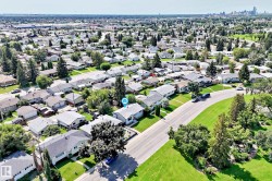 Aerial view showcasing a residential neighborhood with a variety of detached homes - 