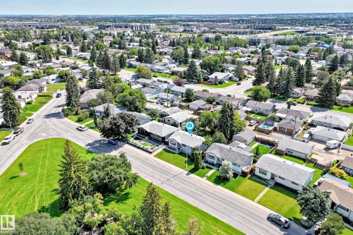 Residential street featuring established homes with mature landscaping and paved roadways - 5519 142 Avenue Nw, Edmonton, AB - Outdoor With View