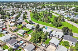Aerial overview featuring residential architecture, established tree canopy, and green spaces - 