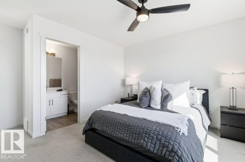 Room featuring light gray carpet, white walls, and a contemporary dark bronze ceiling fan - #49 850 Secord Bv Nw, Edmonton, AB - Indoor Photo Showing Bedroom