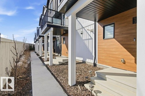 Contemporary exterior design featuring horizontal wood-finish siding and vertical white siding accents - #49 850 Secord Bv Nw, Edmonton, AB - Outdoor With Exterior