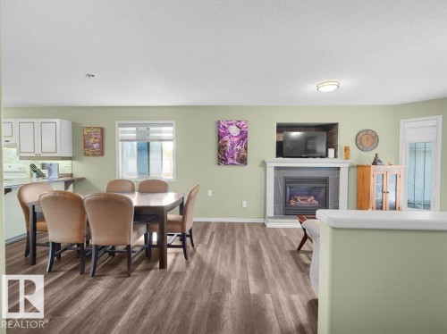 204 Westmews Drive, Fort Saskatchewan, AB - Indoor Photo Showing Dining Room With Fireplace