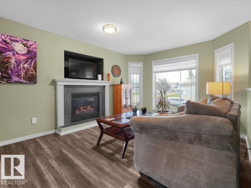 204 Westmews Drive, Fort Saskatchewan, AB - Indoor Photo Showing Living Room With Fireplace