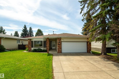 Ranch-style residence featuring a brick facade accent, an attached two-car garage, and a concrete driveway - 6907 19 Avenue Nw, Edmonton, AB - Outdoor With Facade