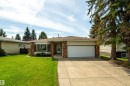 Ranch-style residence featuring a brick facade accent, an attached two-car garage, and a concrete driveway - 6907 19 Avenue Nw, Edmonton, AB  - Outdoor With Facade 