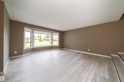 Bright, open living space flooded with natural light through expansive bay windows - 6907 19 Avenue Nw, Edmonton, AB - Indoor Photo Showing Other Room