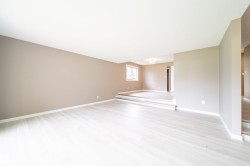 Spacious interior featuring light-toned wood-finish flooring and neutral wall tones - 