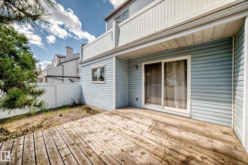 Ground-level wood deck with light blue siding exterior - 290 Lancaster Terrace Nw, Edmonton, AB - Outdoor With Deck Patio Veranda With Exterior