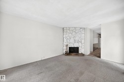 Stone-clad fireplace with a black firebox and hearth - 
