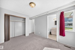 Carpeted room with a full closet featuring bi-fold doors - 