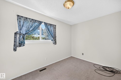 Bright interior room featuring a window with natural light, light-colored walls, and a ceiling-mounted light fixture - 290 Lancaster Terrace Nw, Edmonton, AB - Indoor Photo Showing Other Room
