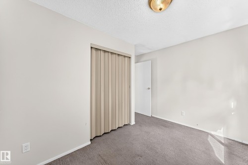 Interior room featuring light gray wall paint, gray carpeting, and a white ceiling - 290 Lancaster Terrace Nw, Edmonton, AB - Indoor Photo Showing Other Room