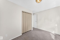Interior room featuring light gray wall paint, gray carpeting, and a white ceiling - 