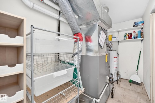Utility room featuring a furnace unit, water heater, and overhead ductwork - 290 Lancaster Terrace Nw, Edmonton, AB - Indoor