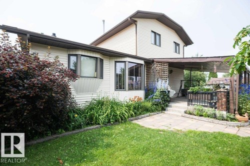 Exterior featuring horizontal siding, dark trim, and a bay window - 10711 108 Avenue, Westlock, AB - Outdoor With Deck Patio Veranda