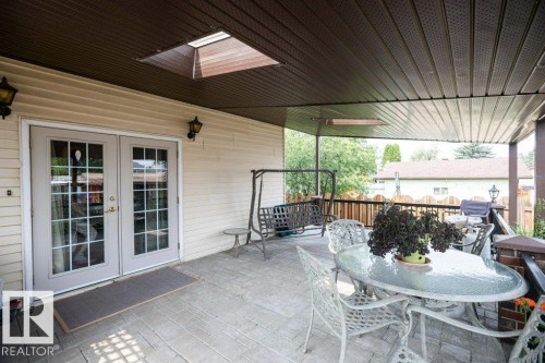 Covered patio with a patterned concrete surface - 10711 108 Avenue, Westlock, AB - Outdoor With Deck Patio Veranda With Exterior