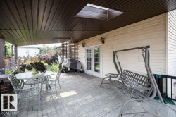 Covered patio featuring an imprinted concrete floor, overhead lighting, and a skylight - 
