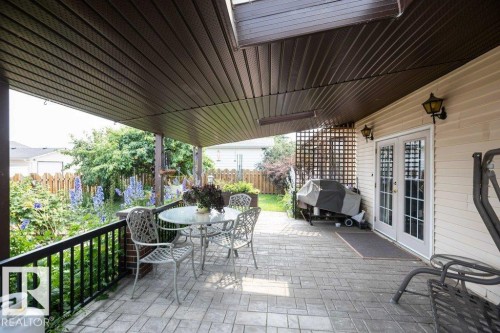 Covered patio featuring a patterned paver surface - 10711 108 Avenue, Westlock, AB - Outdoor With Deck Patio Veranda With Exterior