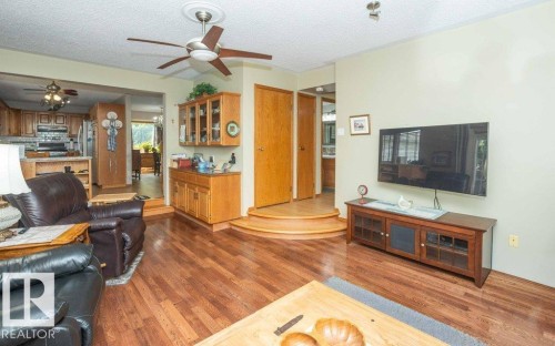 Spacious living area featuring wood-finish flooring, a ceiling fan with light, and recessed lighting - 10711 108 Avenue, Westlock, AB - Indoor Photo Showing Living Room