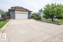 Split-level residence featuring a two-car garage, dark brick accents, and light-colored siding - 10711 108 Avenue, Westlock, AB  - Outdoor 