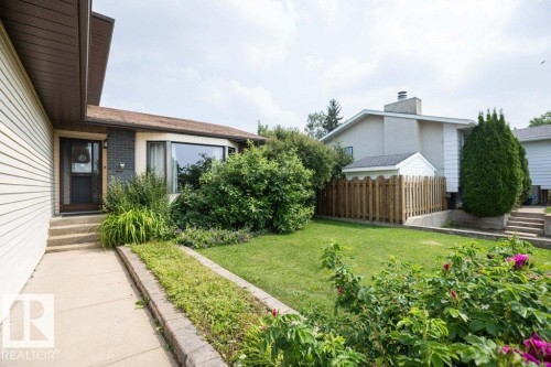 Residential exterior with beige siding and a prominent bay window - 10711 108 Avenue, Westlock, AB - Outdoor