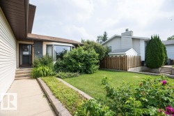 Residential exterior with beige siding and a prominent bay window - 