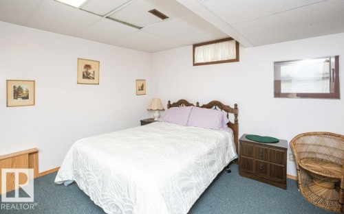 Bedroom featuring drop ceiling, recessed lighting, and blue carpeting - 10711 108 Avenue, Westlock, AB - Indoor Photo Showing Bedroom
