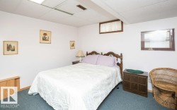 Bedroom featuring drop ceiling, recessed lighting, and blue carpeting - 