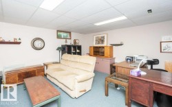 Carpeted room with a drop ceiling featuring integrated fluorescent lighting - 