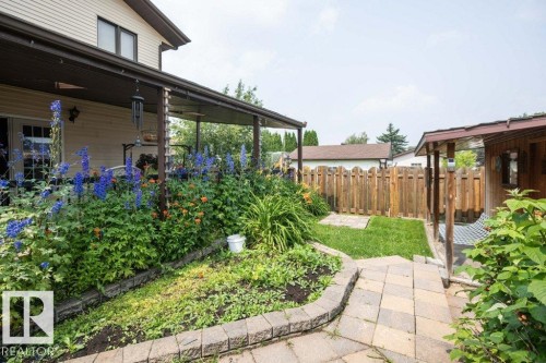 Covered patio with an exterior light fixture and double glass doors - 10711 108 Avenue, Westlock, AB - Outdoor With Deck Patio Veranda
