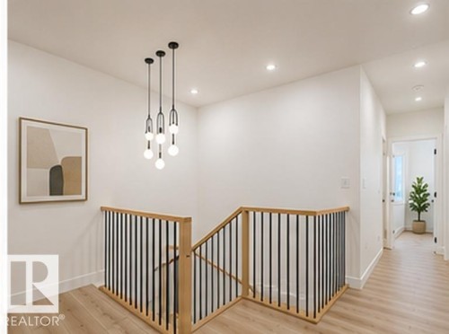 Upper landing featuring wood-finish flooring and a modern chandelier - 3320 Chickadee Drive Nw, Edmonton, AB - Indoor Photo Showing Other Room
