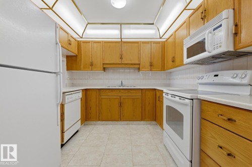 #208 9926 100 Av, Fort Saskatchewan, AB - Indoor Photo Showing Kitchen With Double Sink