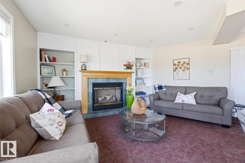 #208 9926 100 Av, Fort Saskatchewan, AB - Indoor Photo Showing Living Room With Fireplace