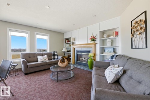 #208 9926 100 Av, Fort Saskatchewan, AB - Indoor Photo Showing Living Room With Fireplace